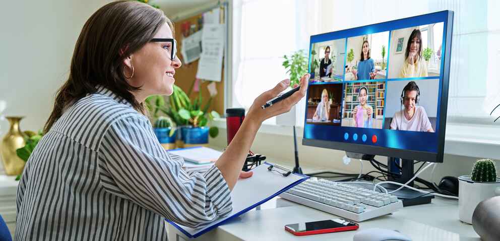 Female teacher working at home, online lesson with group of students